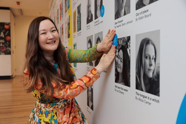 Lyn Dickens putting her winner's sticker on a wall decal