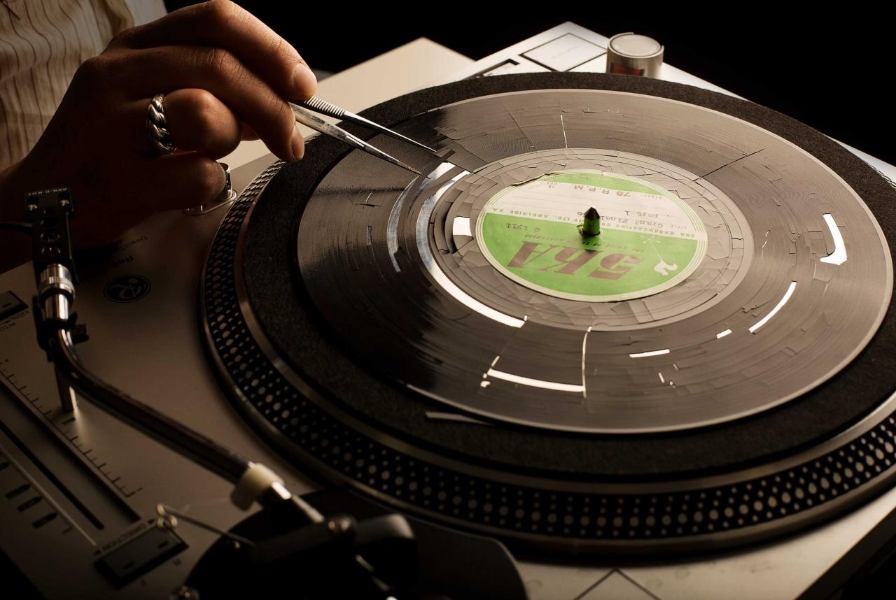 Delaminating acetate record disk being prepared for recording remnant content.