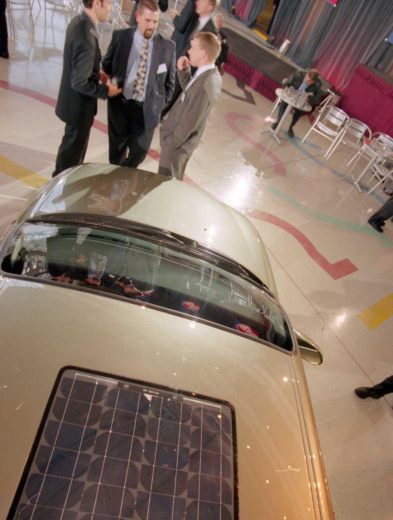 Holden’s ECOmmodore project lead engineers discuss the solar panels on car's roof. SLSA: BRG 213/199/8/2/154 