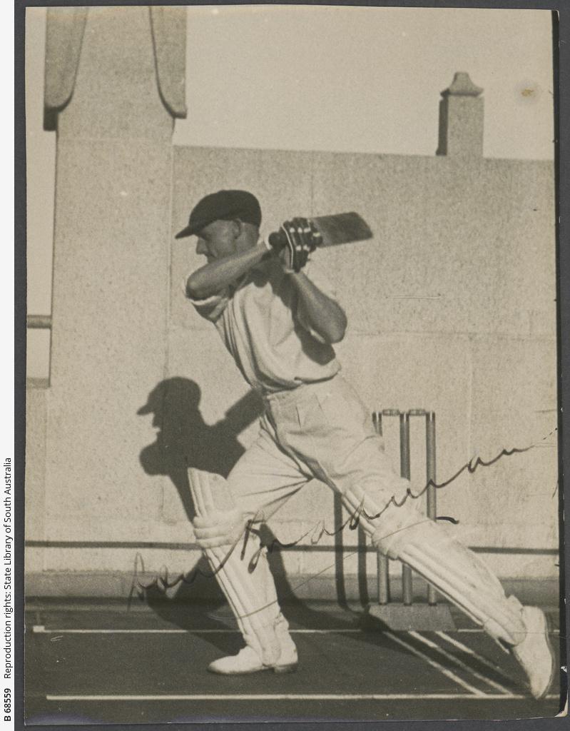 Photograph of Don Bradman in Photograph of Don Bradman in front of a wicket in a walled area, completing a drive, 1936. SLSA: B 68559f