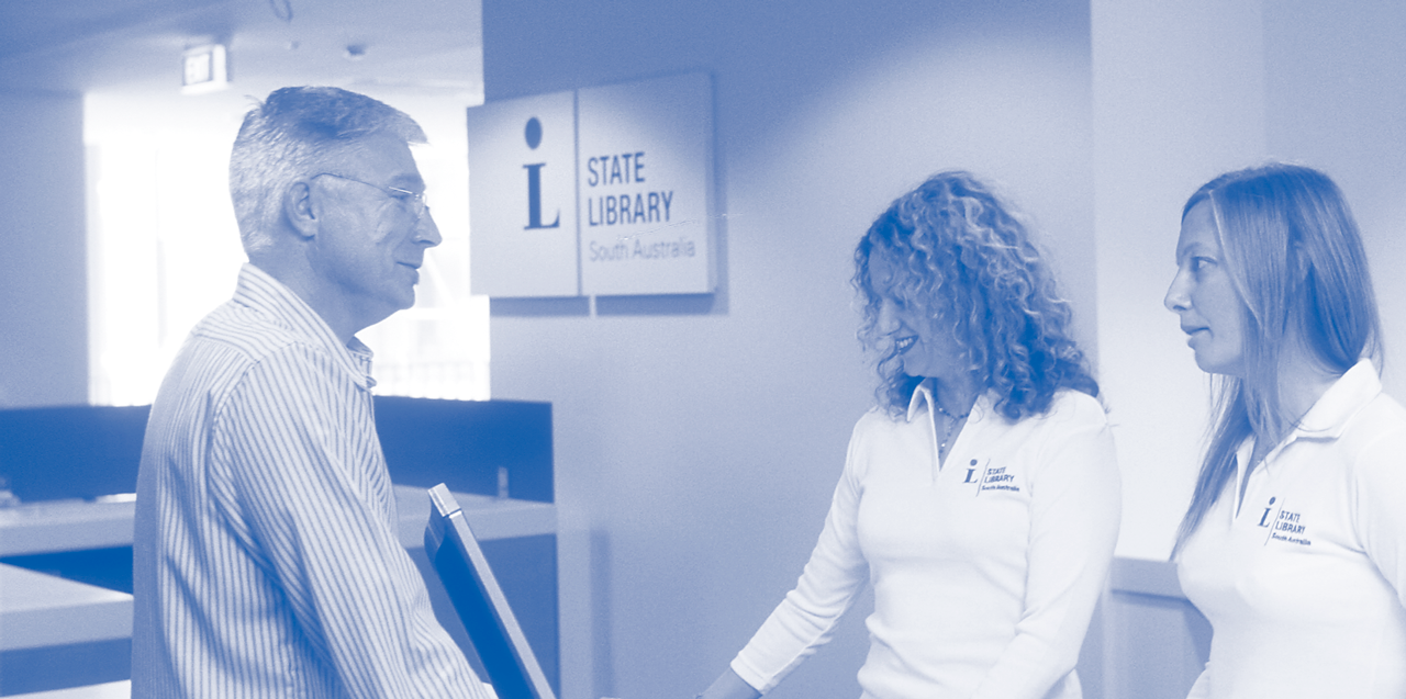 Search like a librarian. Librarians assisting a customer at the Information Desk.