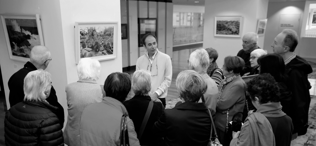 Frederic Mouchet talking to audience at his exhibition