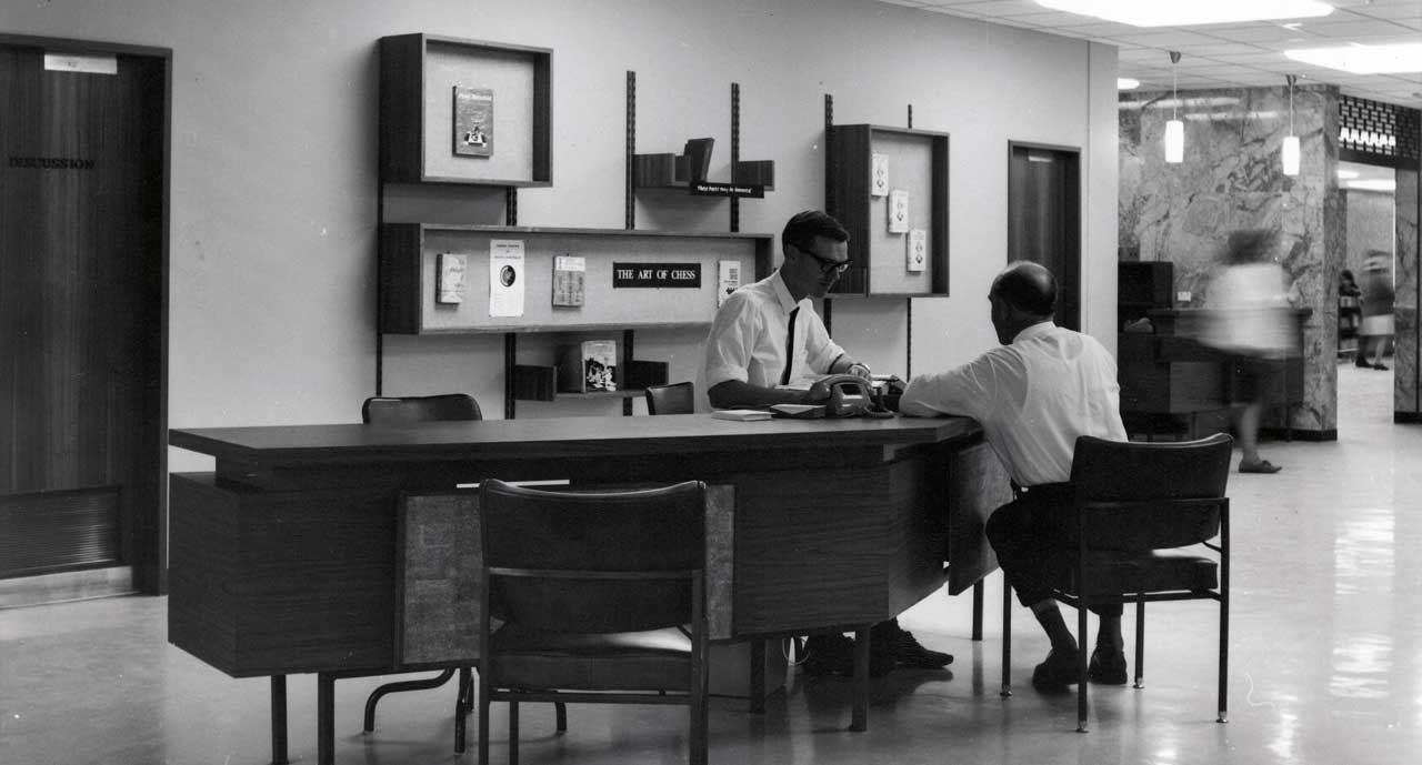 Librarian assisting a customer [SLSA: B 72589/3]