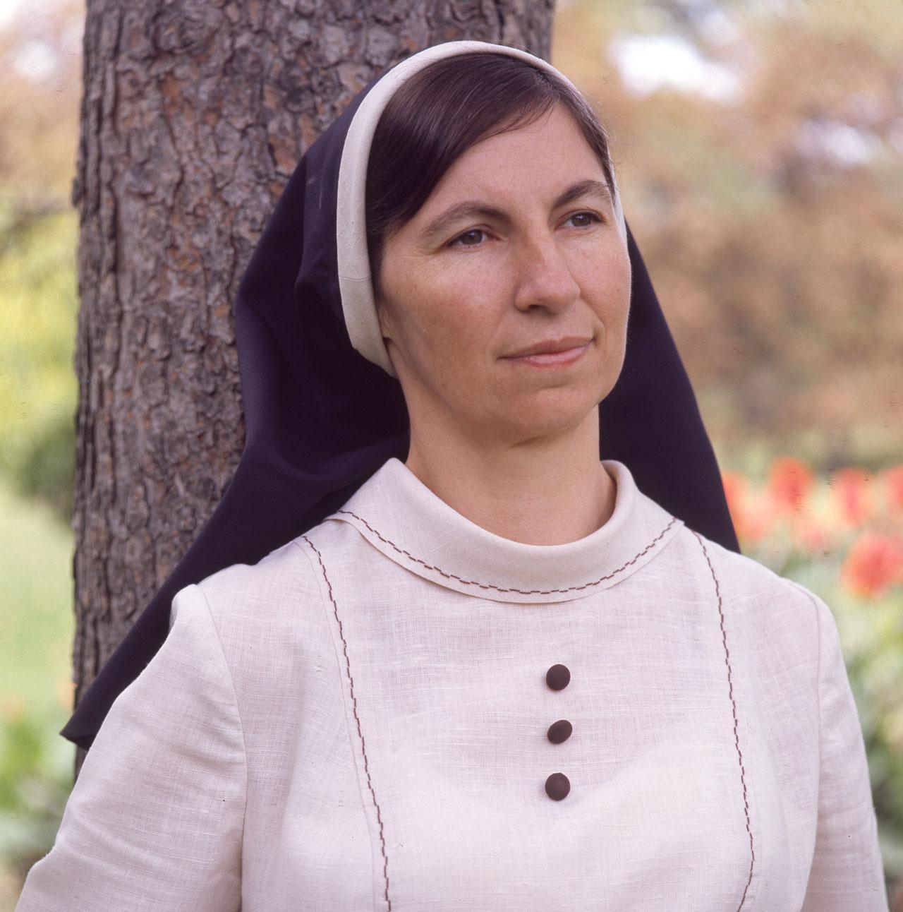 Sister Janet Mead standing near a tree.