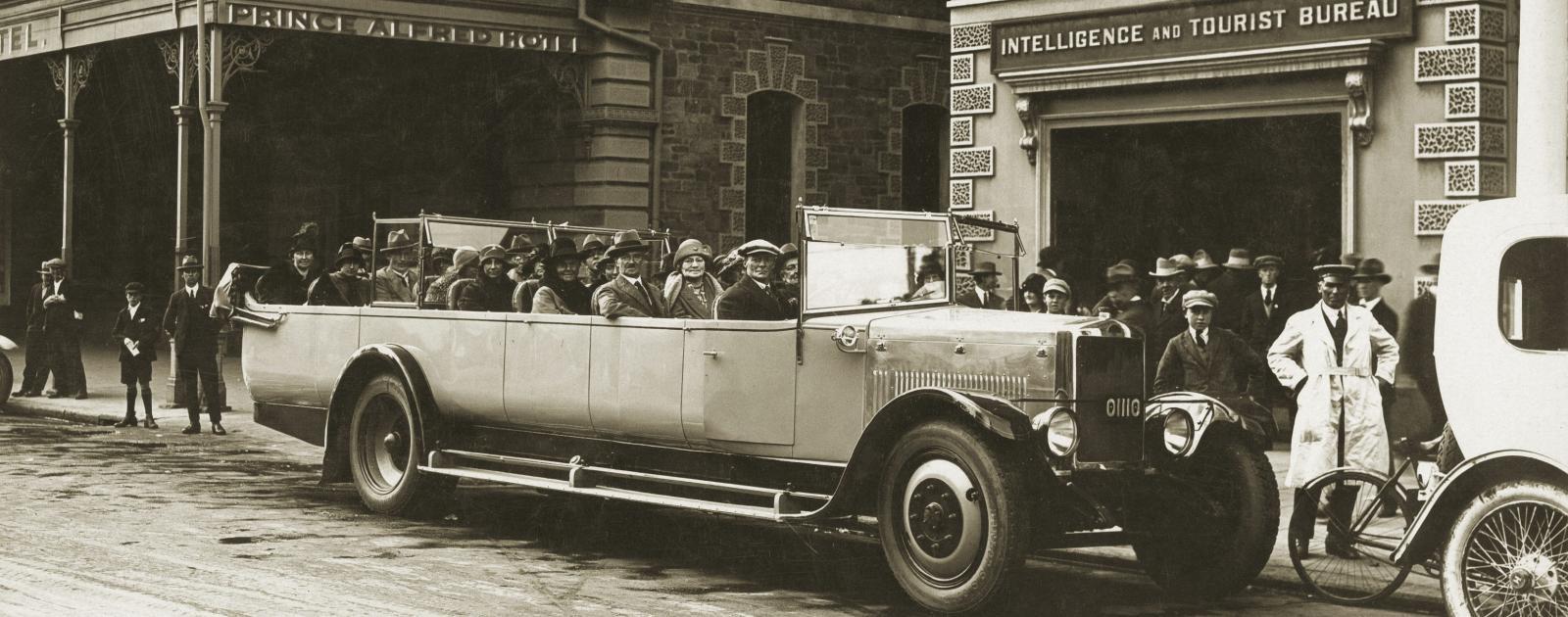 Charabanc parked in front of the Intelligence and Tourist Bureau, King William St, 1926. SLSA: B 3996