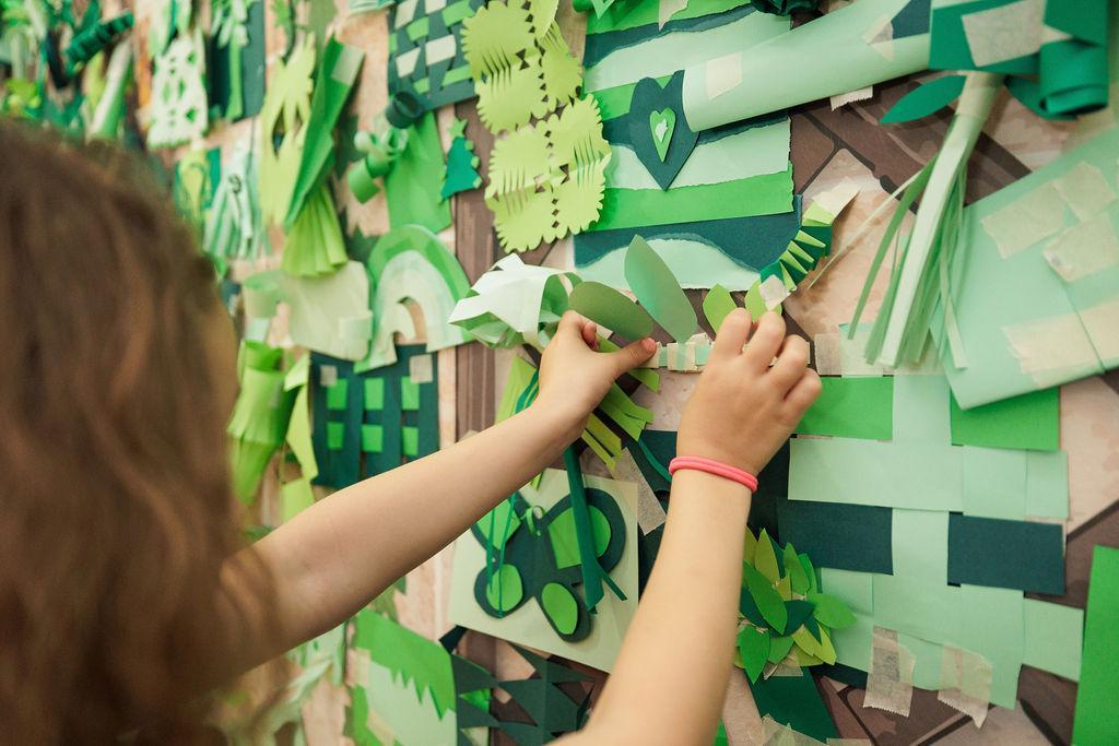 Youth adding their fantastic foliage to the wall.