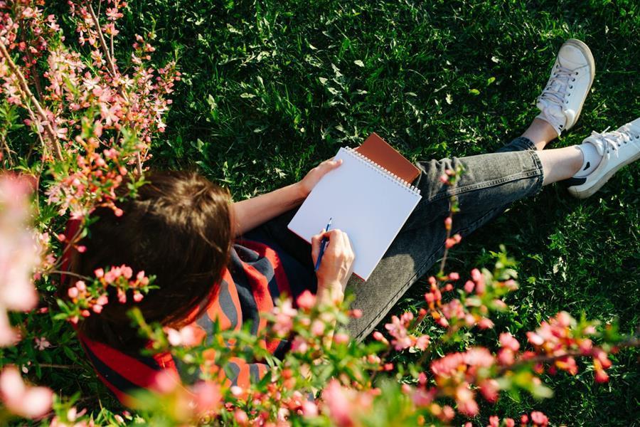 stock image of someone writing in the garden