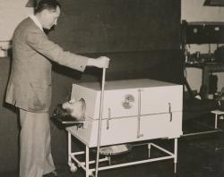 Donald Both demonstration the portable iron lung. SLSA: PRG 1776/2/20