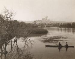 Two men in rowboat, view of Adelaide in distance, c 1880