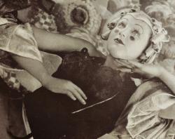 A reclining Thelma Thomas in her modernist version of Columbine character in play, 'The Merry Death'.