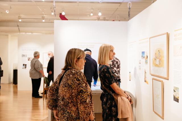 People viewing the Phil Cummings exhibition at the State Library of SA