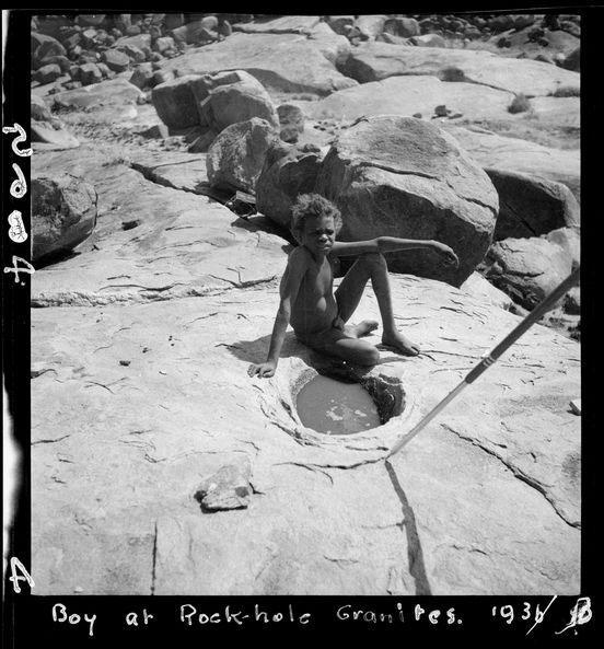 Boy at a rock-hole at the granites, 1936. Photo by CP Mountford.