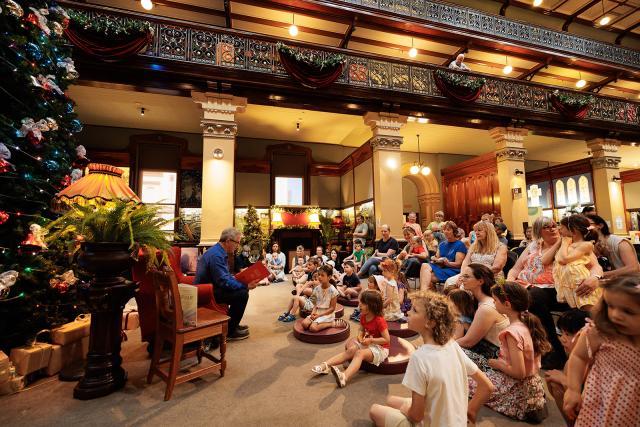 A group of children listen to a storyteller.