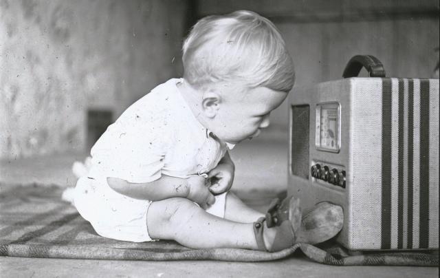 Baby by a radio, c1938. Raymond Gordon, photographer. SLSA: PRG 1605/6/95