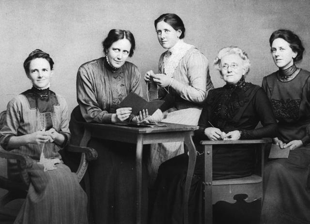 Emily Proud with her three daughters and stepdaughter seated around a table