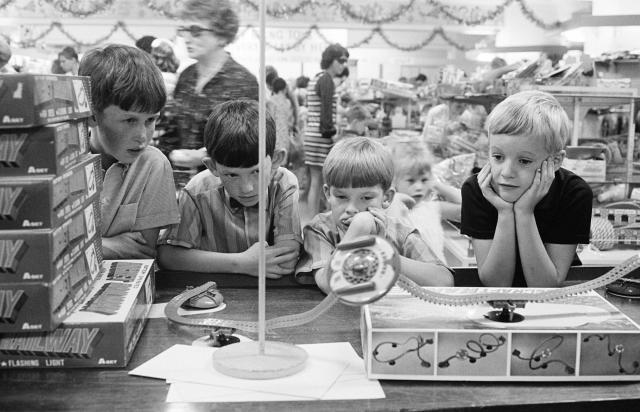Children looking at toys while Christmas shopping