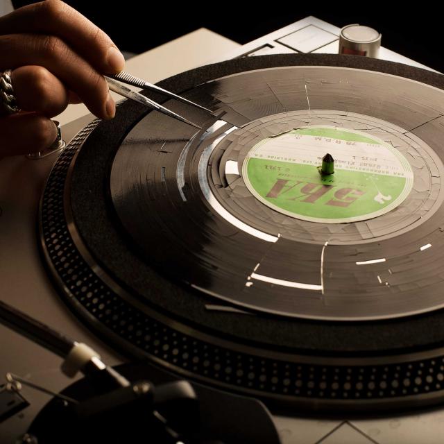 Delaminating acetate record disk being prepared for recording remnant content 