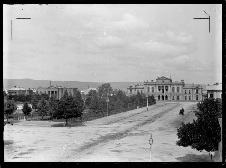 SLSA: B 1552 Court buildings in Victoria Square, Adelaide in 1889. The Local and Insolvency Court building (now Supreme Court) features prominently and the old Supreme Court building (now Magistrates Court) can be seen on the other side of the square. The square's gardens are surrounded by wrought iron fencing.  
