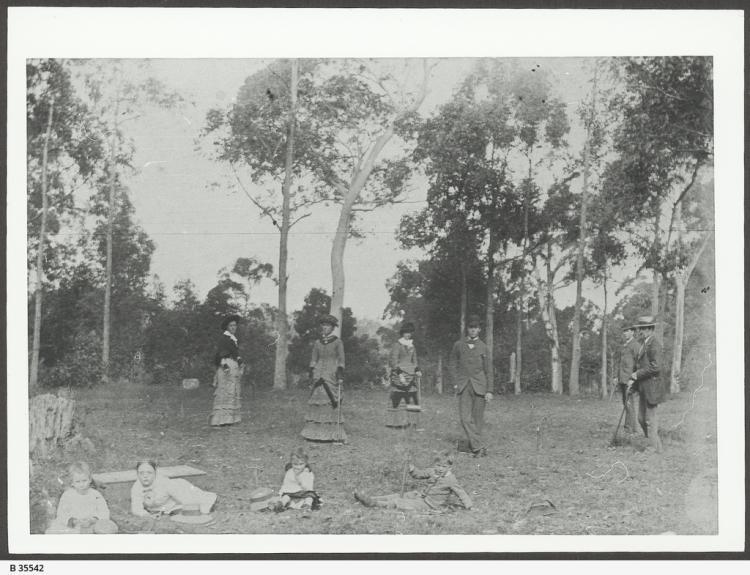 A group of adults and children playing croquet in an area in Clarendon. SLSA: B35542