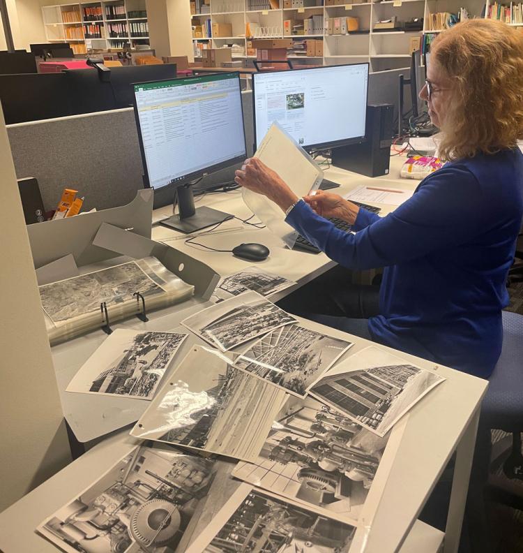 Judy Darwin examining Holden photograph in 2023.