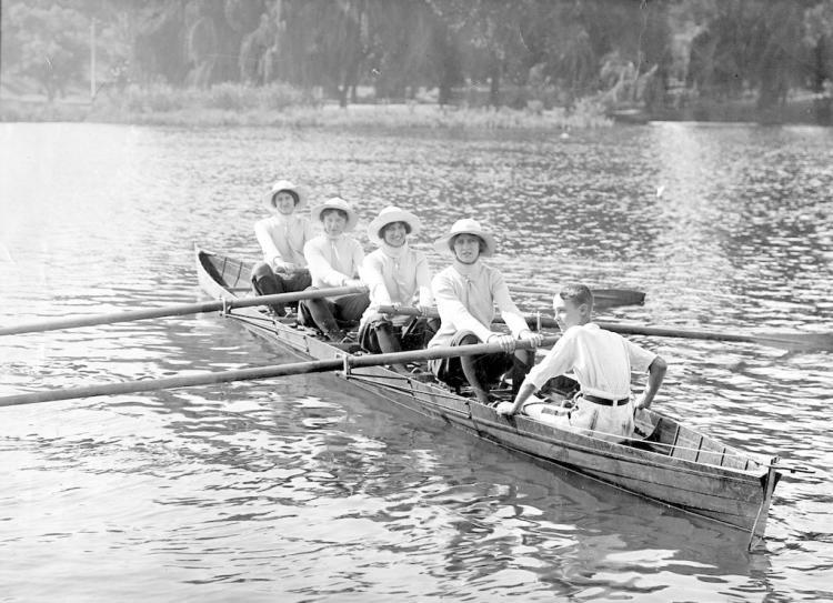 Four women and one male rowing on Torrens Lake