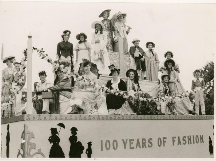 Women on float dressed to showcase 100 years of fashion, 1936