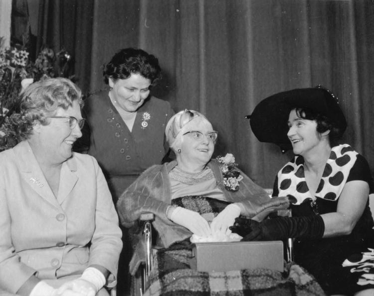 Doris Taylor in wheelchair, centre, surrounded by three female friends