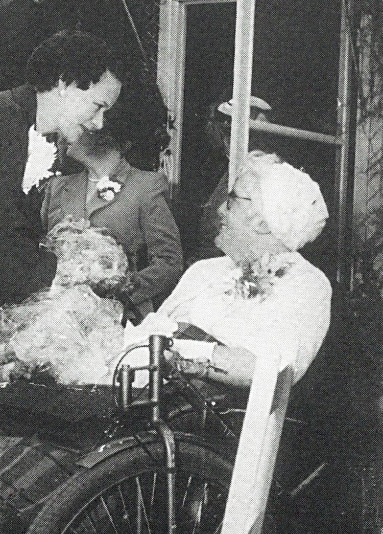Doris Taylor in wheelchair speaking with Lady George at MOW opening, 1954